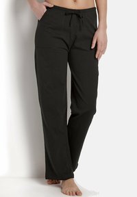 Schwarze, weite Lounge-Hosen mit elastischem Bund und Kordelzug. Mit vorderen Taschen und einer weichen, glatten Textur ausgestattet.