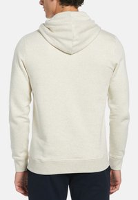 Hoodie in licht beige, gemaakt van zachte stof. Heeft ribgebreide manchetten en een zoom, met een relaxed fit en een gestructureerde achterkant.