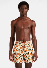 Peldbikses ar krēmkrāsas fonu, kurās ir spilgti oranžs un zaļš citrusaugļu raksts. Elastīga josta ar aukliņas detaļu.