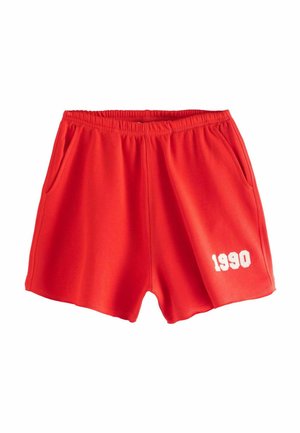 Red, lightweight shorts made of soft fabric. Features an elastic waistband, side pockets, and white "1990" text on the lower right side.