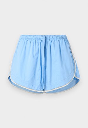 Pantaloncini da donna azzurri con vita elastica, coulisse e rifiniture bianche lungo gli orli curvi su sfondo semplice.