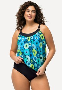 Bikini med en luftig, flerfärgad överdel med cirkulära mönster i blått och grönt, som är parat med en svart bikiniunderdel. Justerbara remmar ingår.