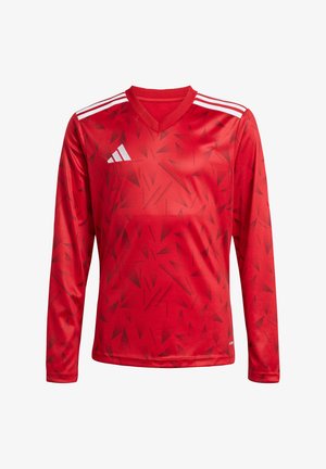 Maglia da calcio rossa a maniche lunghe con collo a V. Presenta un motivo geometrico in diverse tonalità di rosso. Accenti bianchi a tre strisce sulle spalle.