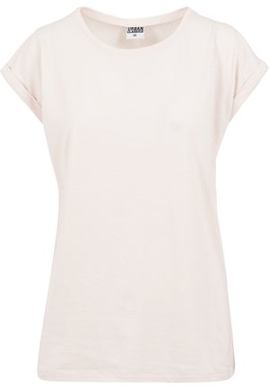 Camiseta de manga corta en color rosa claro, hecha de algodón suave. Presenta un corte relajado con mangas enrolladas y un cuello redondo. Textura simple y suave.