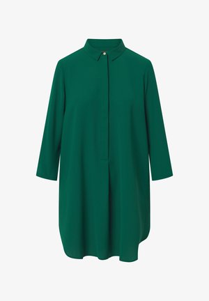 Zöld, galléros tunikaing, háromnegyedes ujjakkal, sima textúrával, elől gombos záródással és enyhén ívelt szegéllyel.