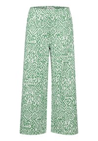 Breda byxor i vitt tyg med ett grönt geometriskt mönster. Har en slät struktur och ett åtsittande midjeband.