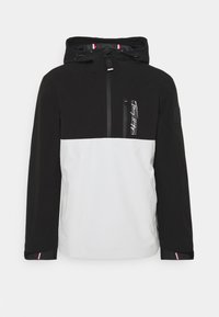 Černobílé pulovrové sako s kapucí, obsahující přední zip, náprsní kapsu a červenobílé akcenty na rukávech.