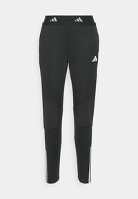 Zwarte sportbroek met een aansluitend ontwerp, voorzien van reflecterende accenten en een brede tailleband. Gemaakt van ademend materiaal met paneel details.