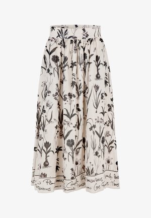 Falda con estampado floral en tejido color crema; presenta dibujos botánicos negros y una banda blanca bordada en el dobladillo. Silueta acampanada.