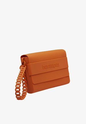 Borsa a tracolla in silicone arancione con motivo testurizzato a nido d'ape. Presenta una robusta tracolla a catena modellata e una chiusura frontale con il nome del marchio.