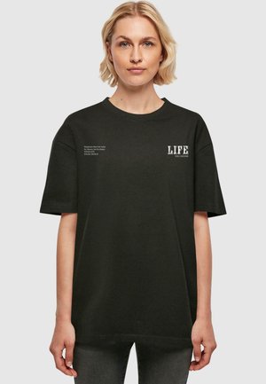 Black oversized t-shirt made of cotton. Short sleeves and a round neckline. Features white text, including "LIFE" and additional phrases on the front.