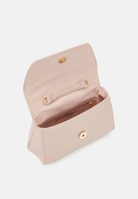 Blush pink faux leather handbag with a gold snap closure, a smooth texture, and a spacious interior featuring a zip pocket and strap.
