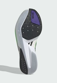 Semelle de chaussure de course avec une section en caoutchouc noir texturé, des accents blancs et gris, un logo violet et des détails verts pour un ajout de style.