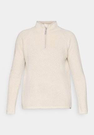 Kremna polovična zip pulover iz teksturirane pletene tkanine, ki ima dvignjen ovratnik in rebraste manšete, ter ravno rob.