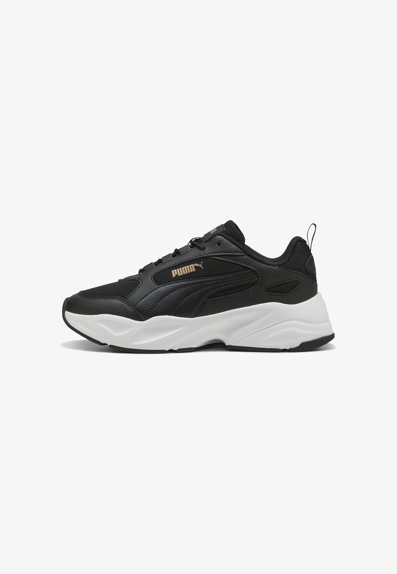 Black Puma sneaker with white thick sole, lace-up design, mesh and leather upper, and beige Puma logo on the side.