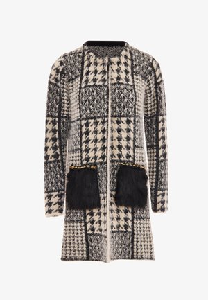 Wool blend coat featuring a houndstooth pattern in black and white, with two faux fur pockets and gold accents at the pocket openings.