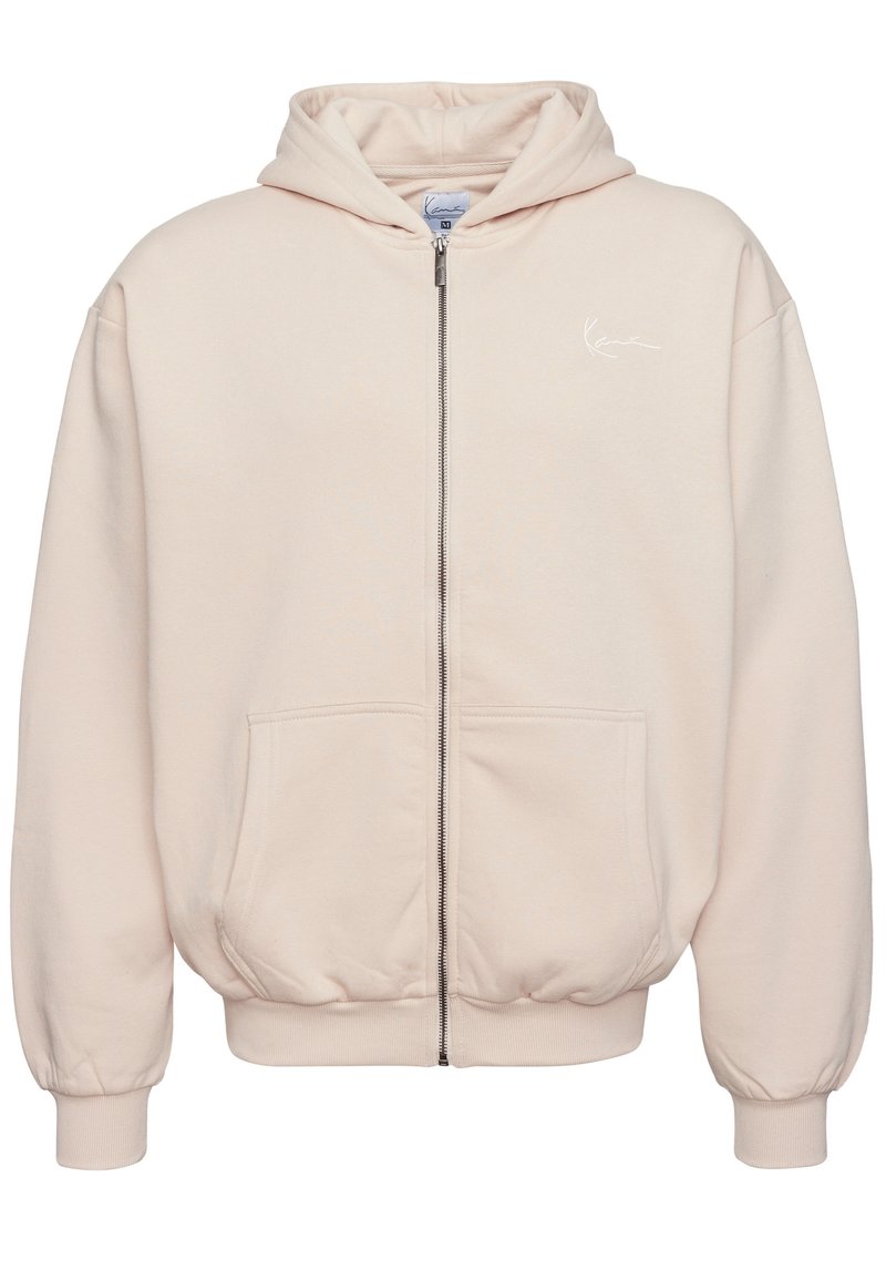 Light pink zip-up hoodie with a drawstring hood, front pockets, ribbed cuffs, and a small white logo on the left chest. Soft cotton material.