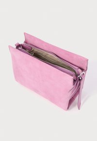 Pink suede crossbody bag with silver zipper, beige interior lining, and adjustable strap on a white background.