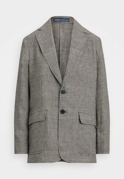 Karirani blazer v črni in beli barvi, ki ima zarezan ovratnik, dve gumbki in dva sprednja žepa. Narejen je iz teksturirane tkanine.