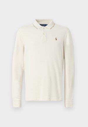 Long-sleeve polo shirt in off-white cotton, featuring a ribbed collar, three-button placket, and a small embroidered logo on the chest.
