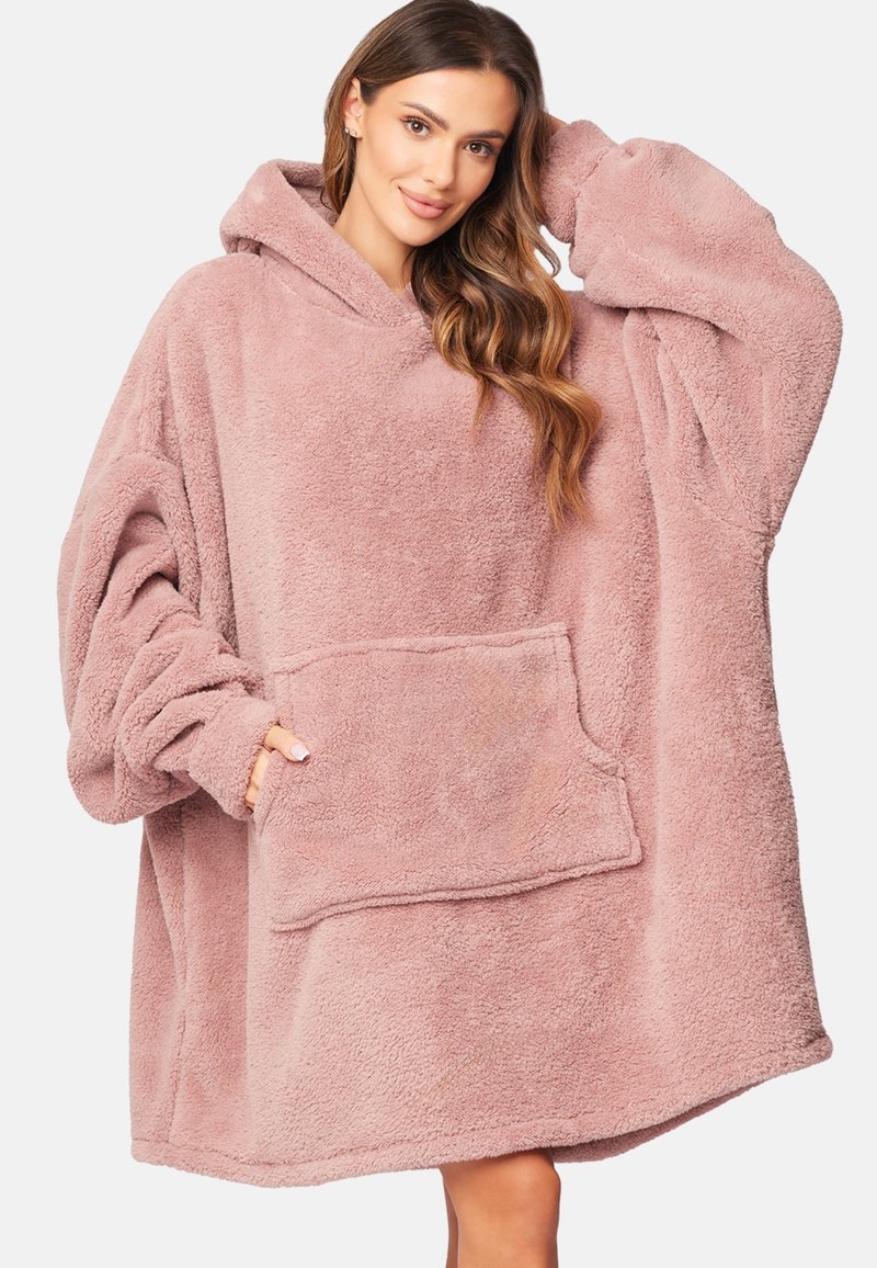 Felpa oversized rosa con cappuccio realizzata in morbido tessuto peluche. Presenta una tasca frontale, maniche ampie e un cappuccio accogliente. Design semplice e confortante.