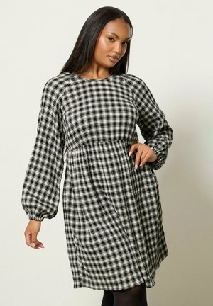 Schwarz-weiß kariertes Kleid mit langen, gepufften Ärmeln, tailliertem Bund und lockerem Rock. Weicher Stoff. 