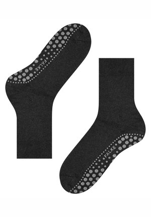 Calzini neri con un motivo a puntini in silicone antiscivolo sulla suola, realizzati in materiale liscio ed elastico con punta e tallone rinforzati.