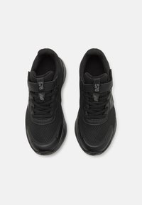 Black athletic shoes with mesh fabric upper, lace closure, and padded collar. Reinforced toe and textured rubber sole. Minimal branding visible.