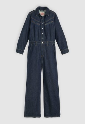 Salopette en denim bleu foncé, manches longues, devant boutonné, deux poches poitrine, et jambes larges avec une taille ceinturée. Accents brodés en jaune.