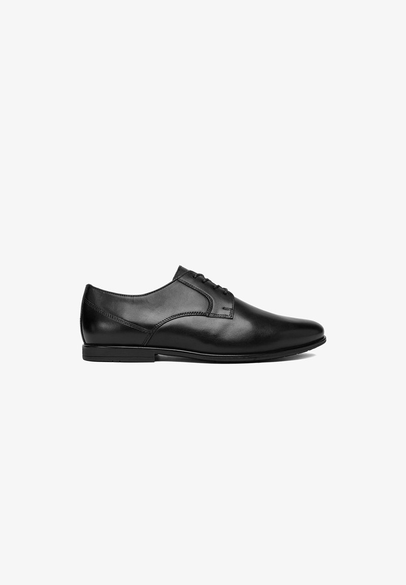 Black polished leather men's dress shoe with closed lacing and a low heel, shown in side profile on a white background.