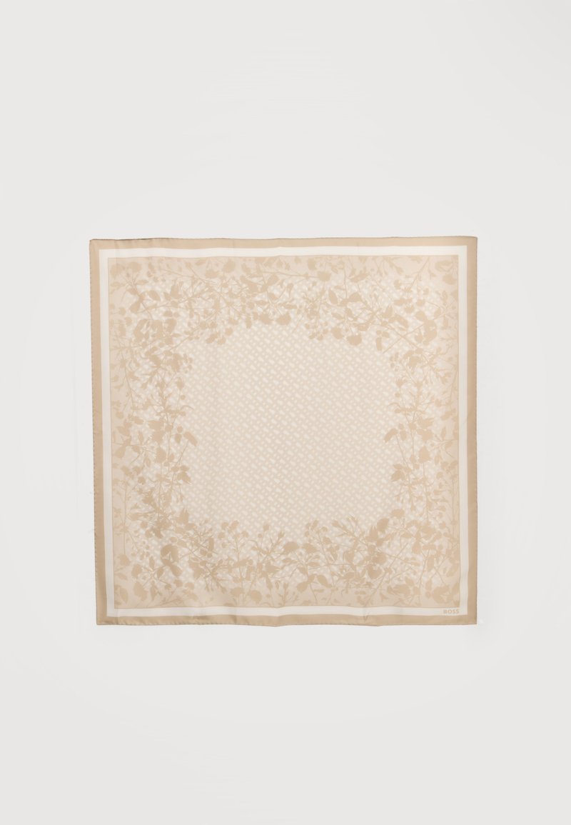 Foulard carré beige clair avec un motif floral discret en bordure et un délicat motif géométrique au centre sur un fond uni.