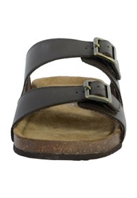 Brown leather sandal with two adjustable buckle straps, a cork footbed, and a textured outsole. Flat design with a rounded toe.
