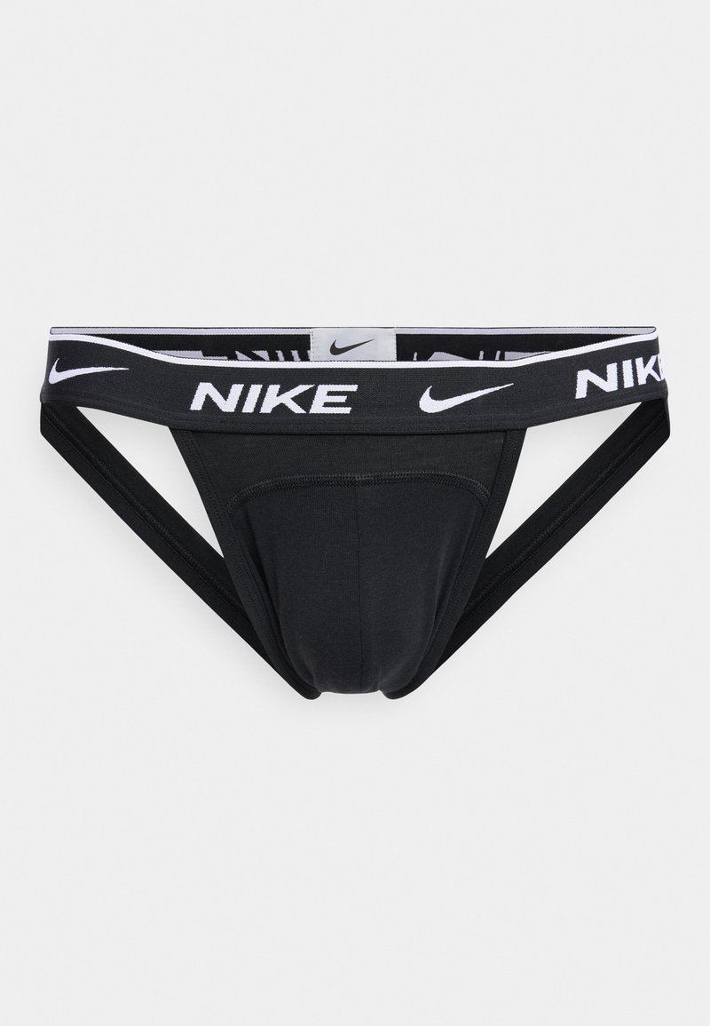 Jockstrap sportif noir Nike avec ceinture élastique blanche à logo et doubles sangles latérales pour le soutien et la ventilation.