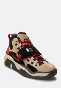 Beige, black, and red Polo Sport sneaker with chunky sole, red patterned laces, black strap, and yellow "RL" detail on side.
