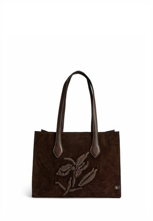 Sac à main en daim marron foncé avec deux poignées en cuir et un motif de feuille cousu sur le devant, sur fond blanc.