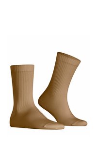 Calzini rigati color sabbia con una finitura liscia, di lunghezza media fino al polpaccio, punte rinforzate e polsini elasticizzati per una vestibilità aderente. Realizzati in tessuto resistente.
