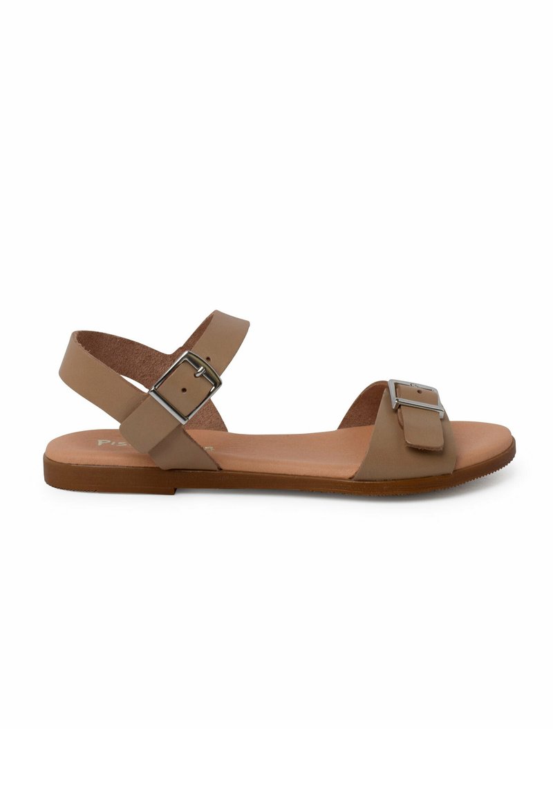 Tan leather sandal with two wide straps, featuring a silver metal buckle detail, flat sole, and minimalist design.