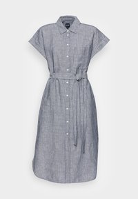 Robe boutonnée en rayures verticales bleues et blanches, à manches courtes, avec une ceinture à nouer à la taille et une poche sur la poitrine. Matière en coton.