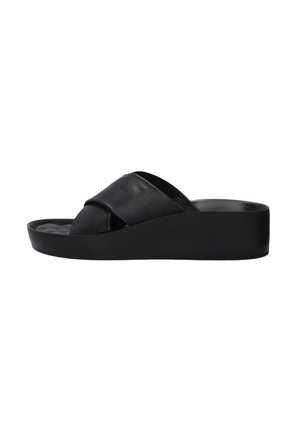 Black platform sandals with a cross strap design, made of textured leather, featuring a wide sole and smooth finish.