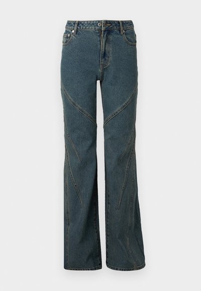 Blue denim jeans with a wide-leg design, featuring curved seam details and standard five-pocket styling. Unfinished hem at the bottom.