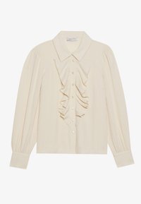 Camisa de manga larga beige con un detalle frontal de volantes, cierre de botones y tejido texturizado. Presenta un collar clásico y puños de manga fruncidos.