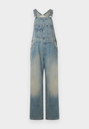 Jeanslatzhosen mit verstellbarem Kreuzträgerdesign, weit geschnittenem Bein, verblasster hellblauer Farbe und vorderen Taschendetails.