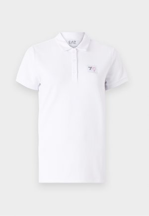 White polo shirt made of cotton with a two-button placket. Features a small printed logo patch on the left chest and short sleeves.