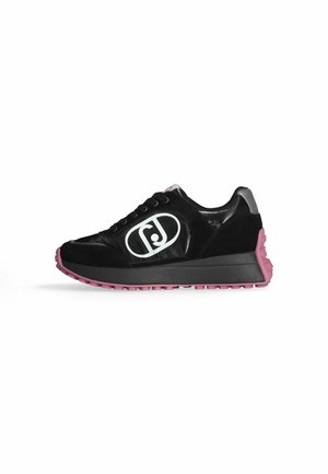 Zwarte sneaker met wit logo aan de zijkant, roze zool, zwarte tussenzool, laag model en vetersluiting.