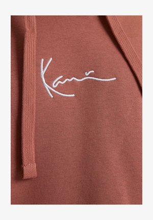 Karl Kani, Kapuutsiga pusa - dark copper white