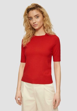Red short-sleeve knitted sweater with a round neck, featuring a seamless design and a subtle logo accent at the bottom.