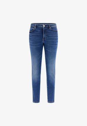 Jean slim bleu pour femmes avec poches avant, fermeture par bouton et fermeture éclair, légèrement délavé aux cuisses et aux genoux.