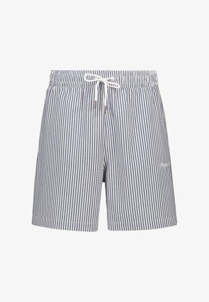 Svītroti peldkostīmi tumši zilā un baltā krāsā. Izgatavoti no viegla auduma, ar elastīgu jostasvietu, saites aizdari un sānu kabatām.