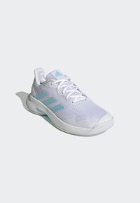 White athletic shoe with mesh upper, light blue accents, and three blue stripes on the side. Features a textured sole. Lightweight design.