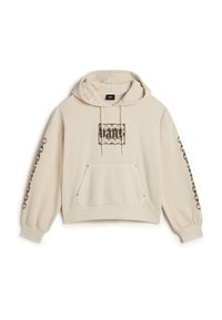 Beige cropped hoodie met een trekkoord capuchon, een voorkeurszak en ingewikkelde zwarte ontwerpen op de borst en langs de mouwen. Zacht materiaal.
